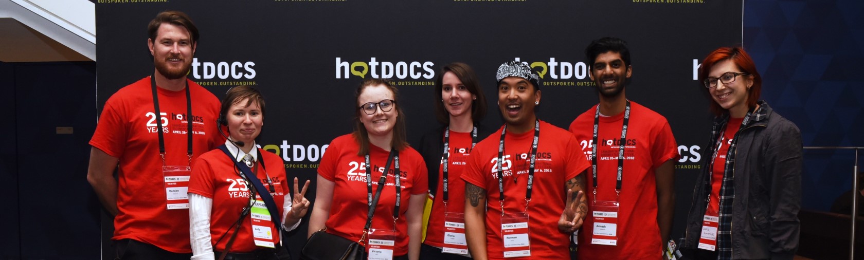 Volunteers pose in front of Hot Docs sign