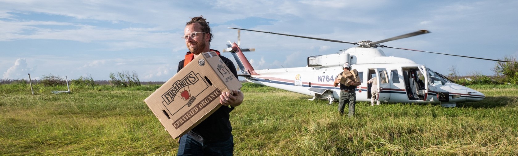 Man carrying food box from helicopter