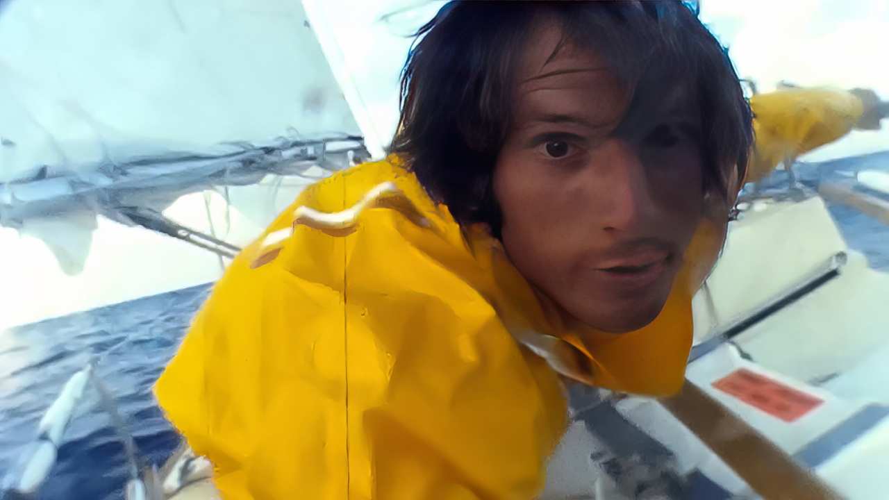 a man with long hair on a boat