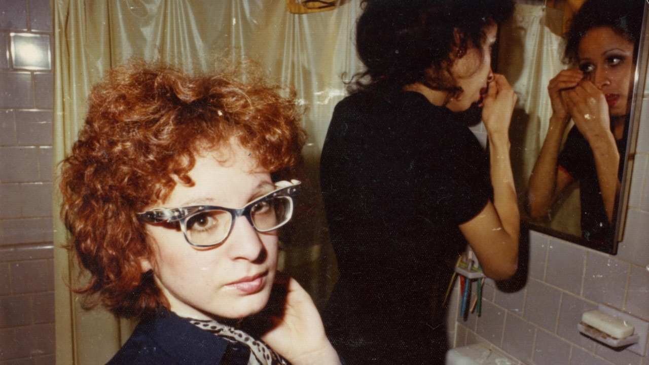 a woman with curly hair and glasses
