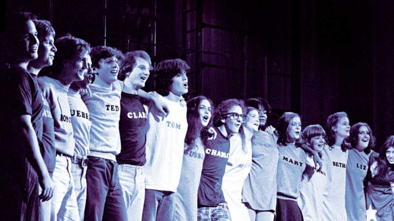a group of actors lined up on a stage