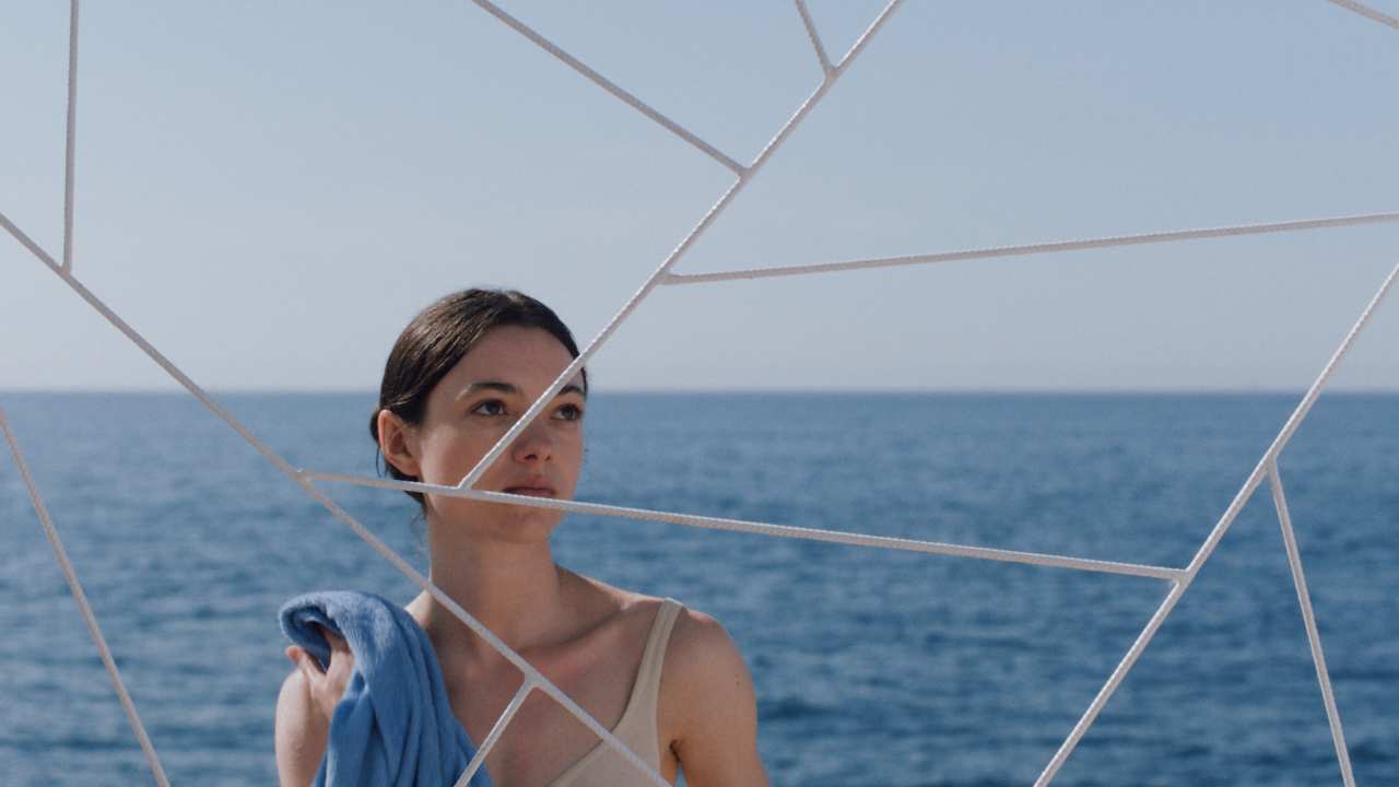 a woman on a boat standing behind a lattice