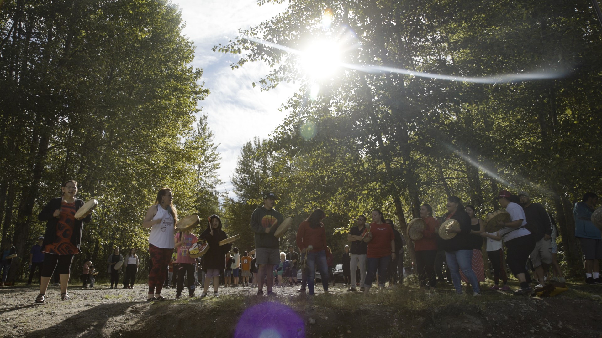 People drumming in the woods