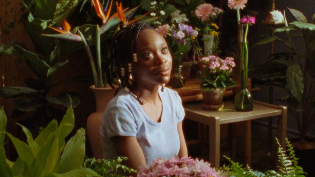 a woman surrounded by plants and flowers