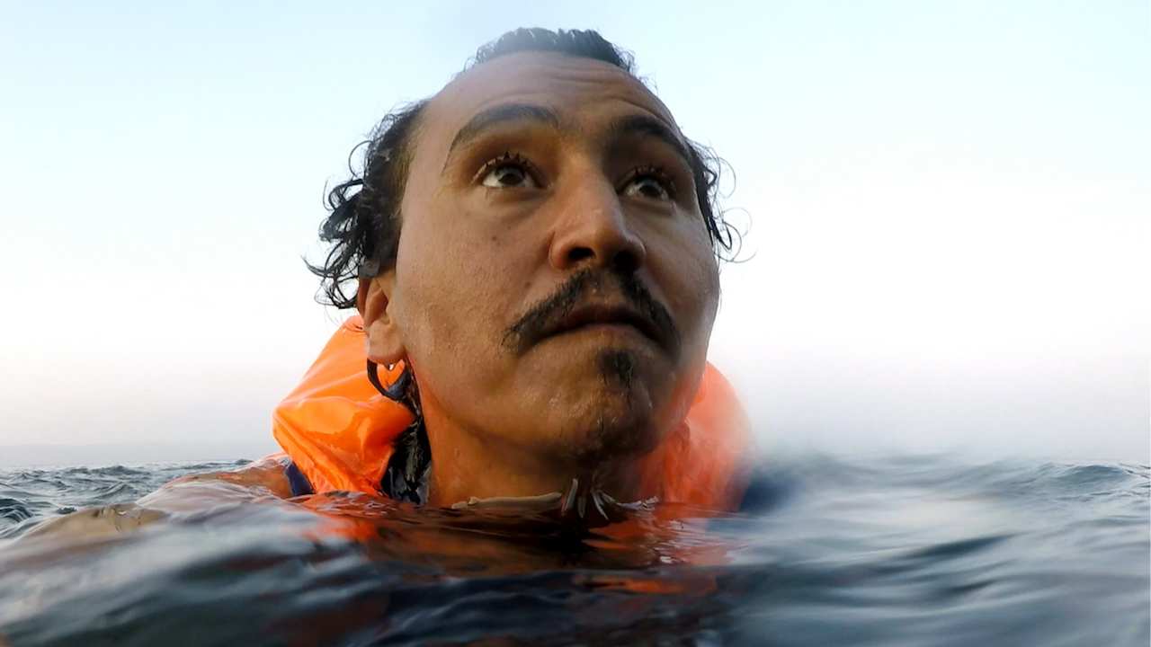 a person's head emerging from the water