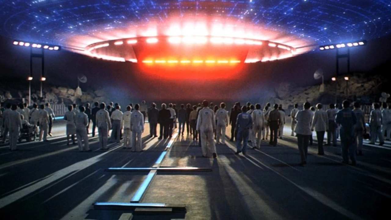 a large group of people looking up at a spaceship