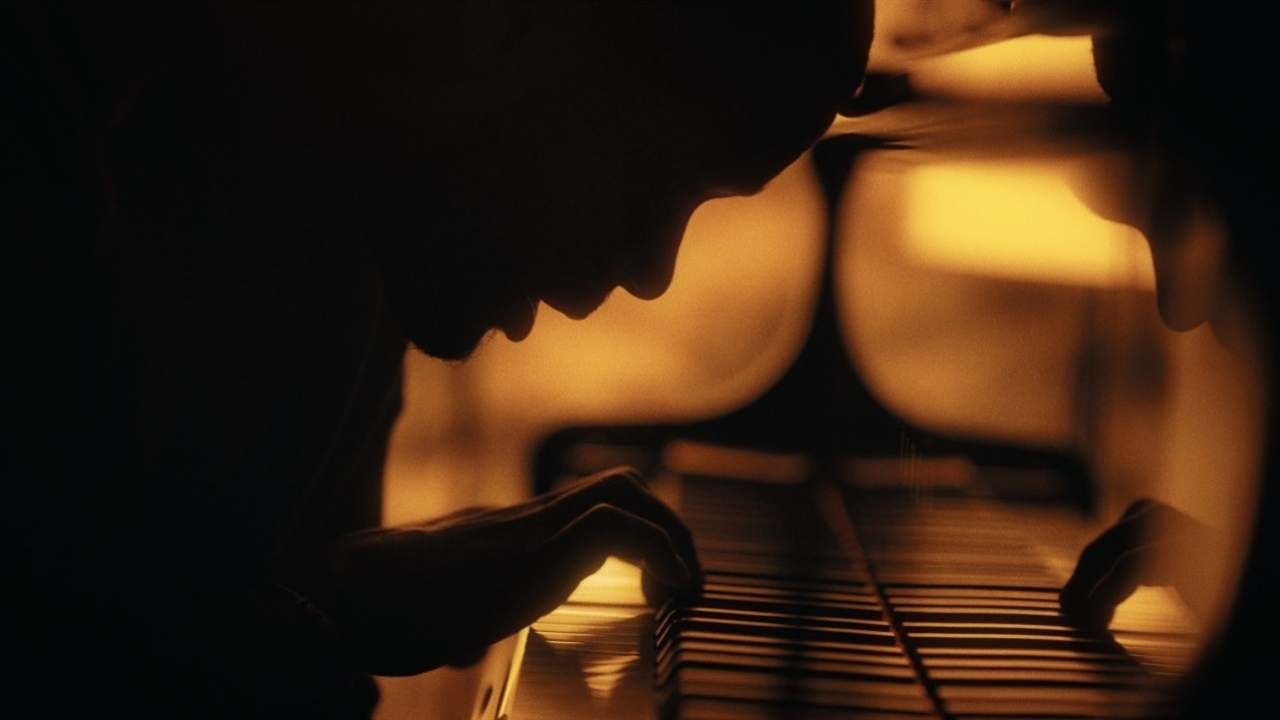 Piano player in silhouette
