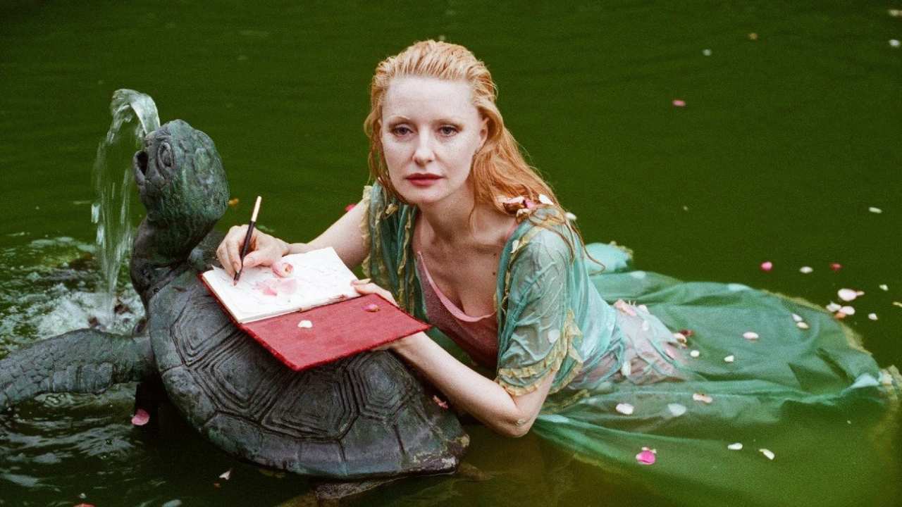 a woman in a turtle fountain writing in a journal