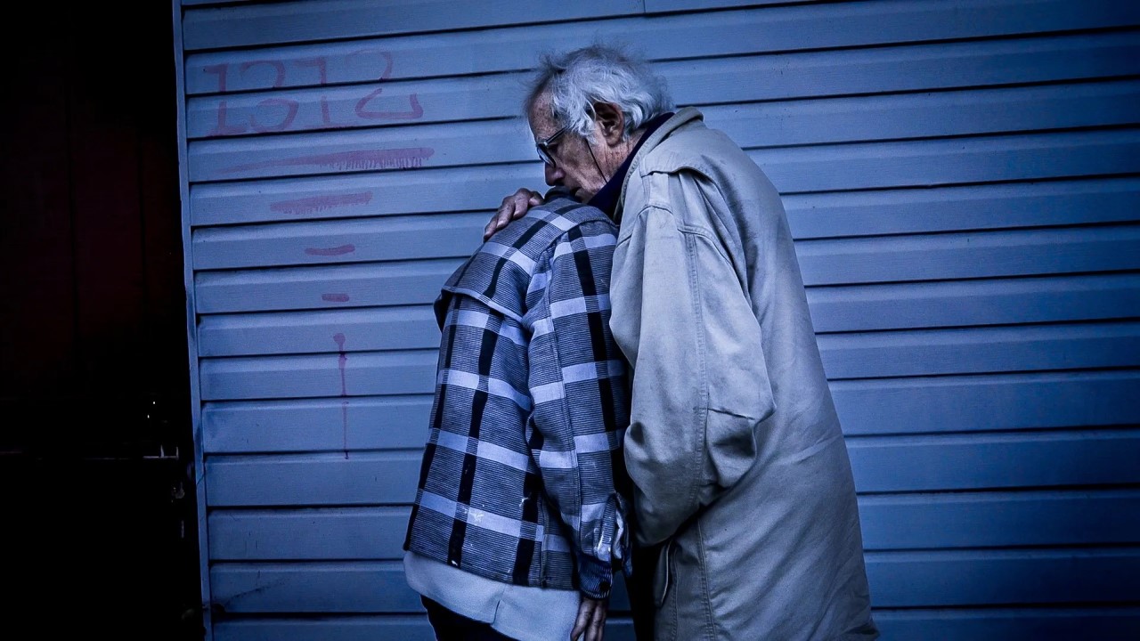 Old man and woman embracing