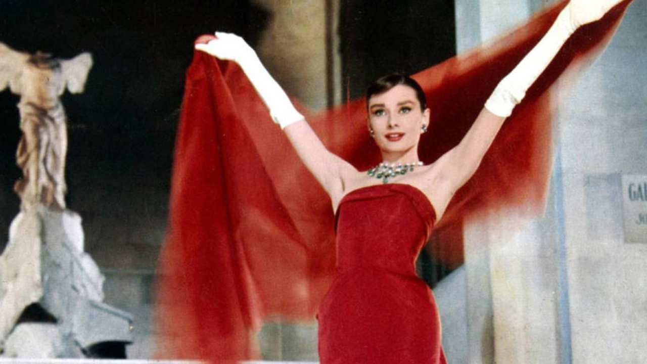 Audrey Hepburn in a red dress with white gloves