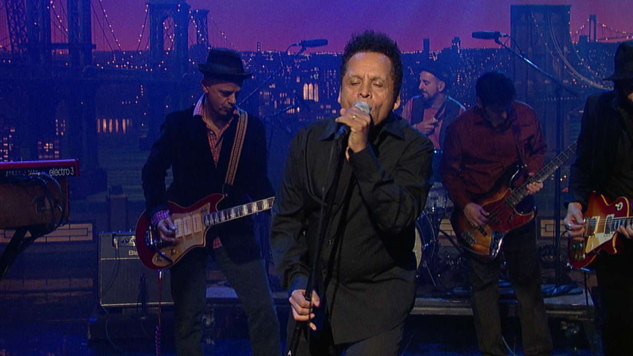 a man singing in front of a band
