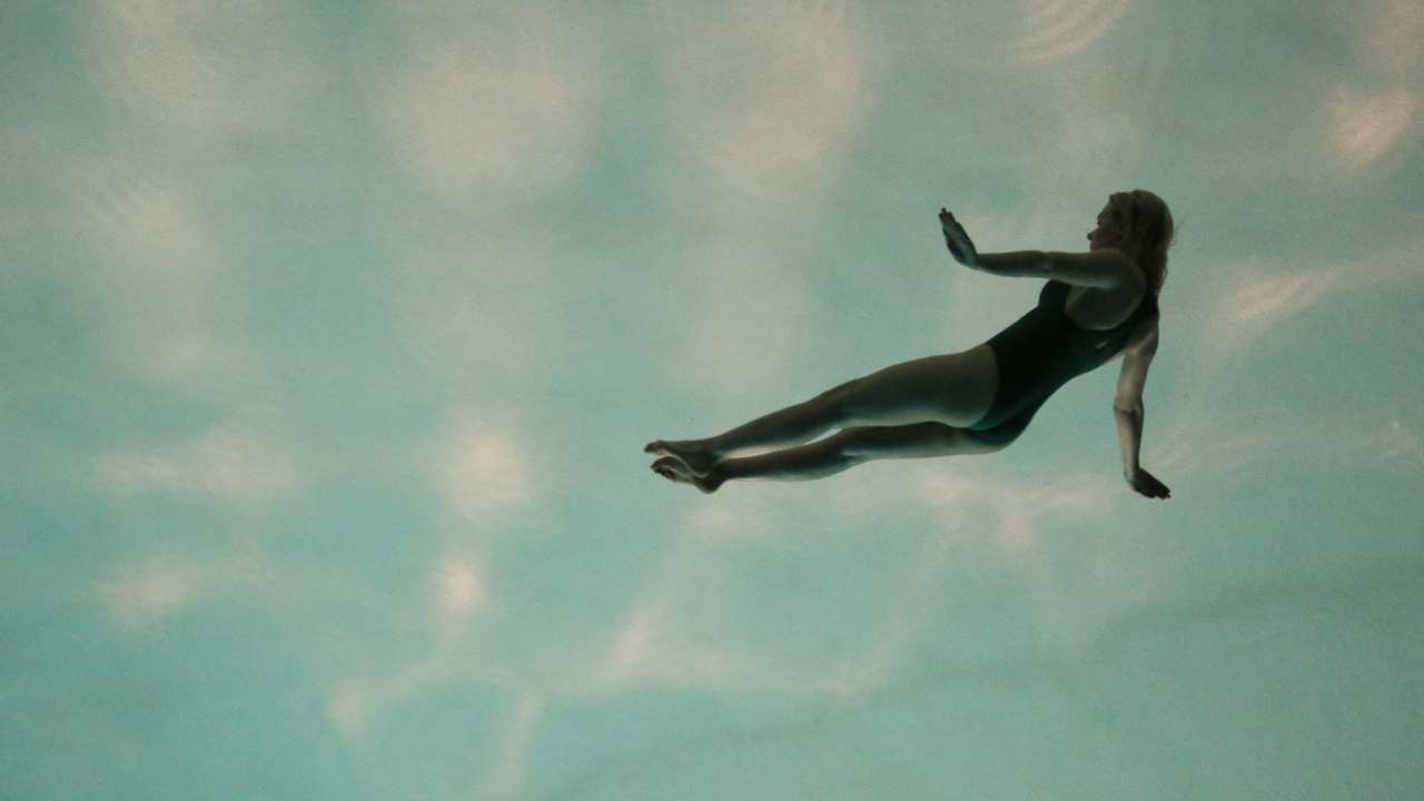 a woman swimming in the sky