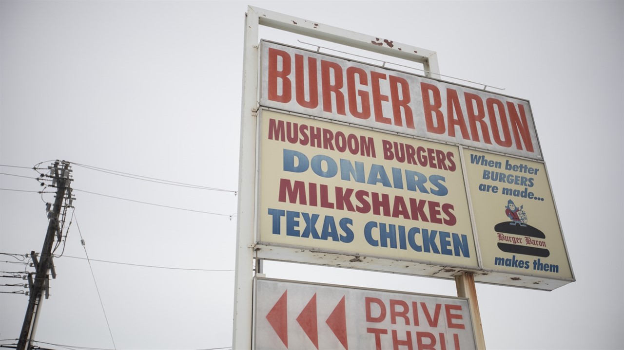 a sign for a burger restaurant listing their menu highlights