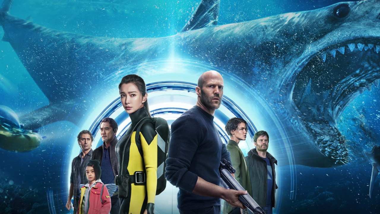 a group of people standing in front of a shark