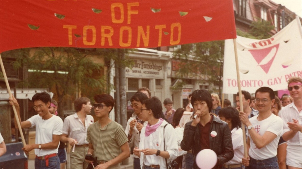 a group of people holding banners and signs