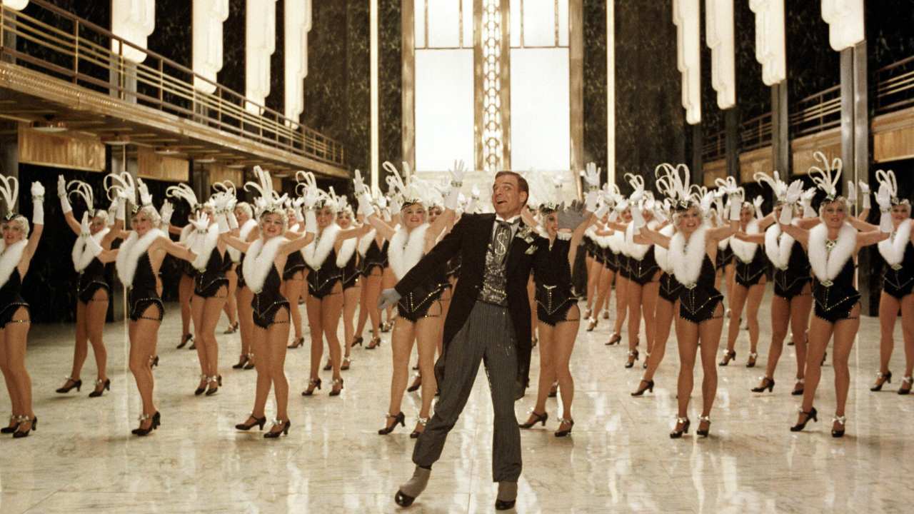 Steve Martin dancing with rows of female dancers