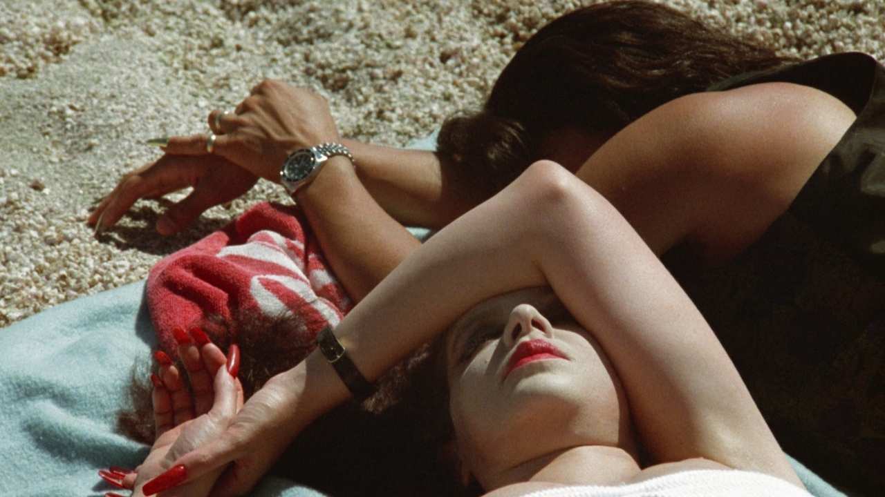 two women laying on a blanket