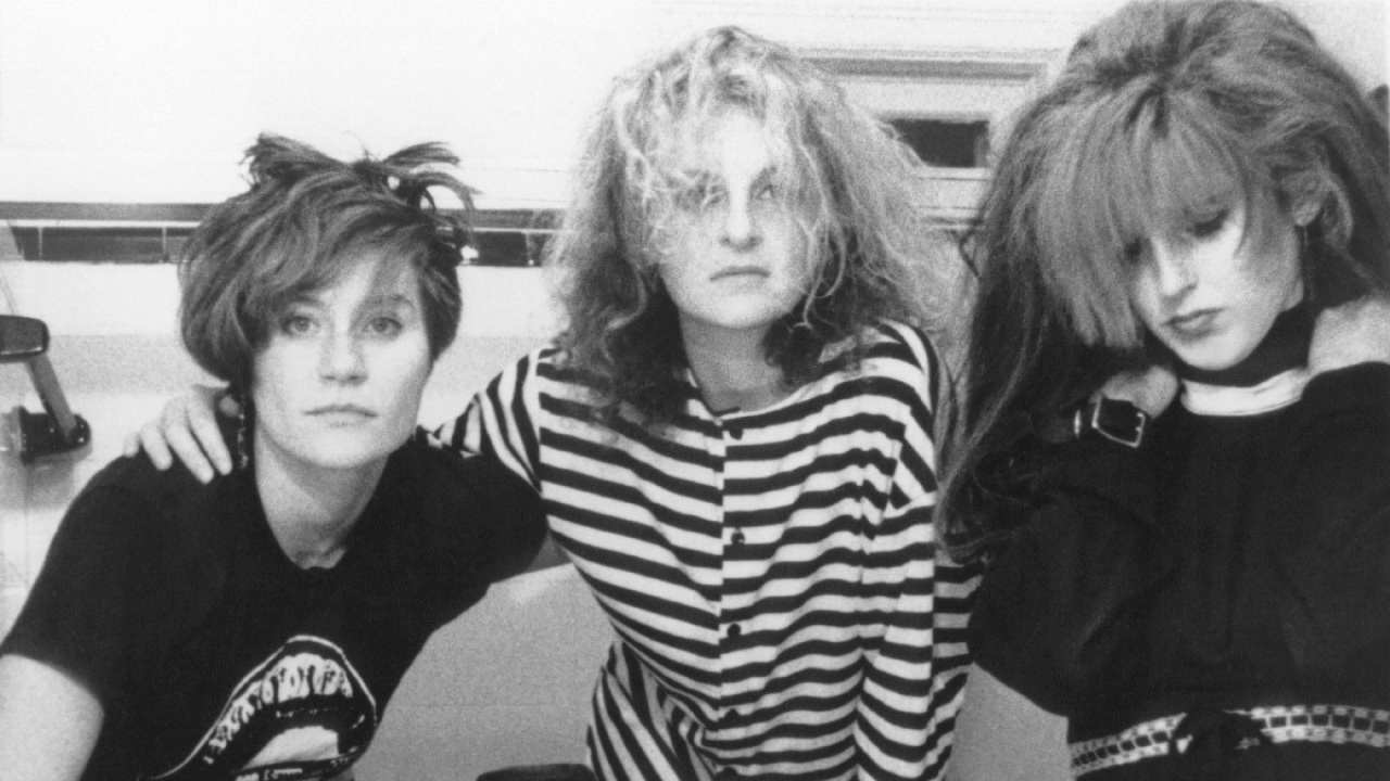 three women posing together in the 1980s