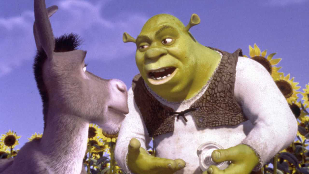 a green ogre talking to a donkey