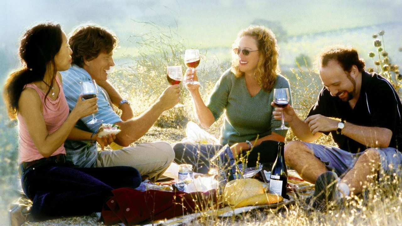 four people drinking wine