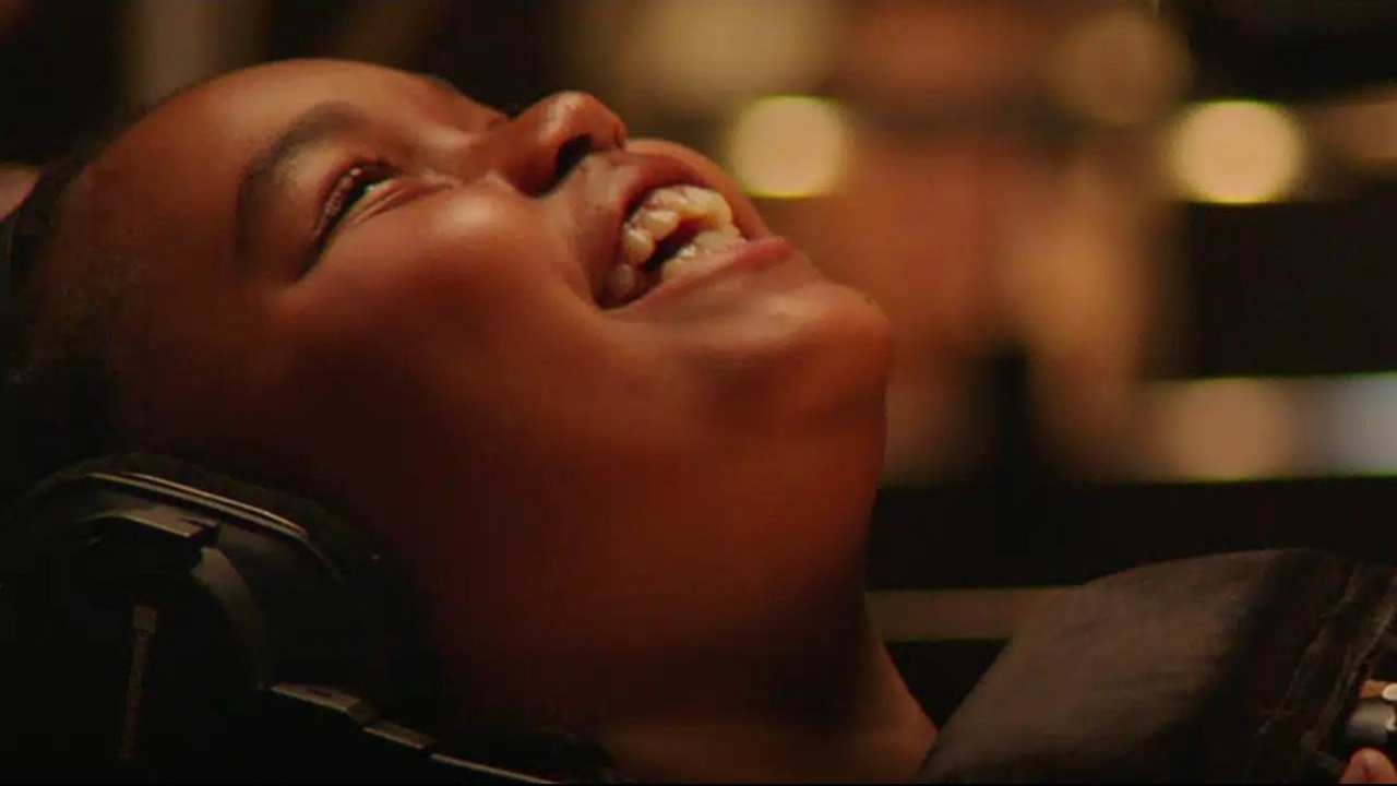 a child with headphones smiling