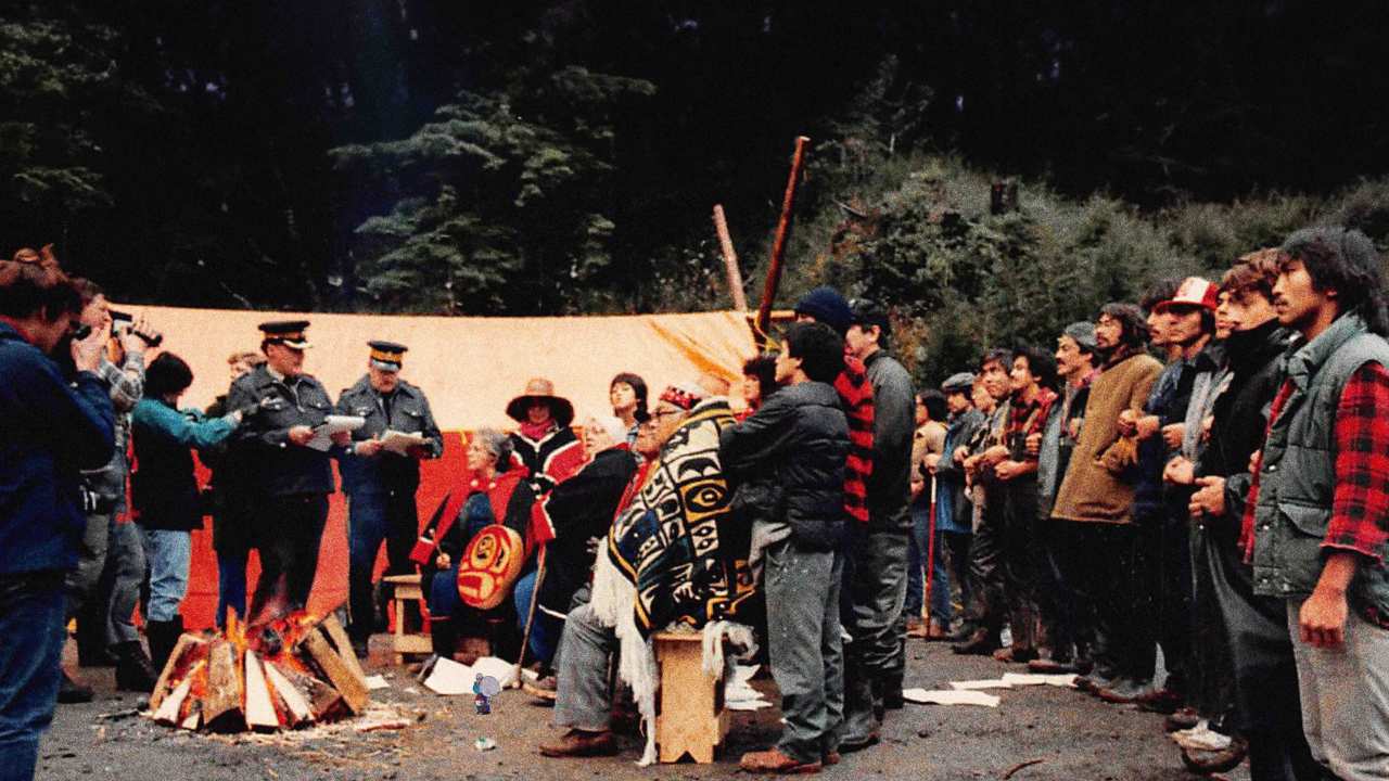 a group of people talking to reporters and police