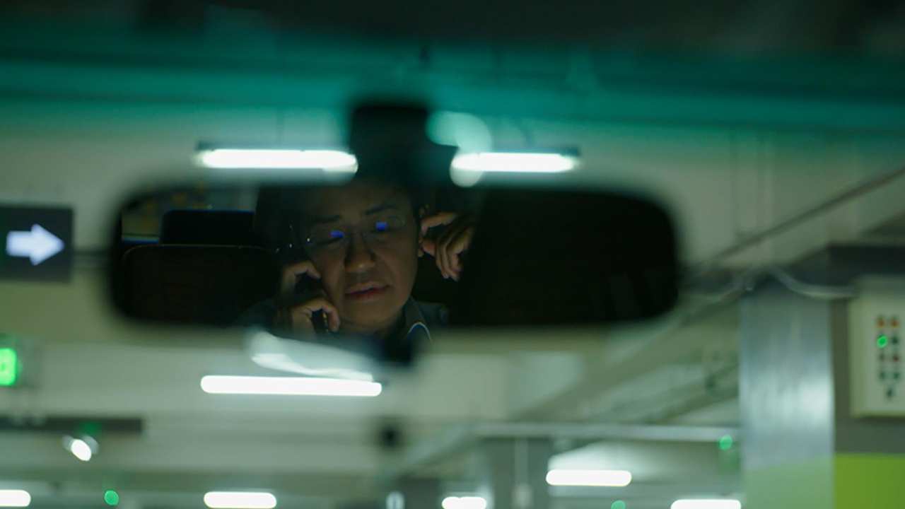 a person's reflection in the rear view mirror