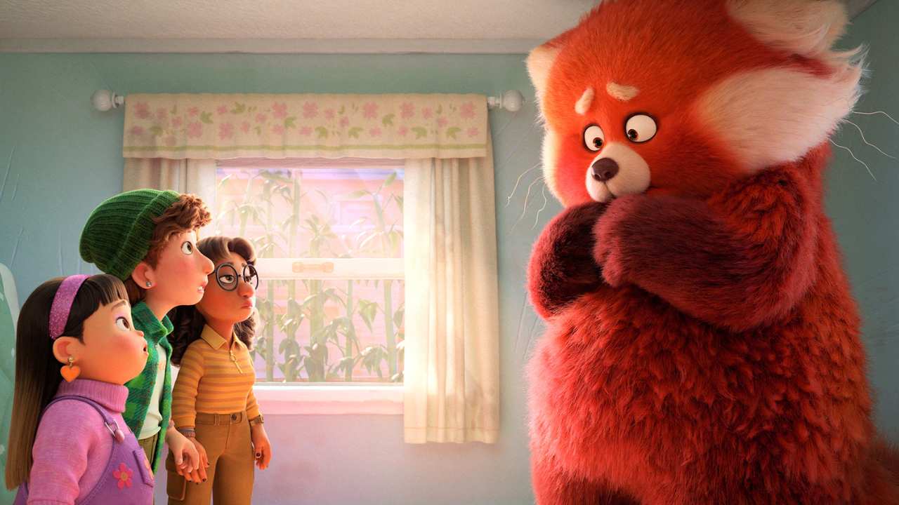 a group of children talking to a giant red panda