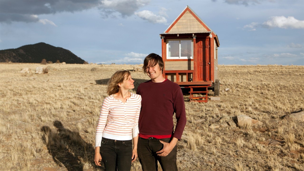 Couple in front of tiny house
