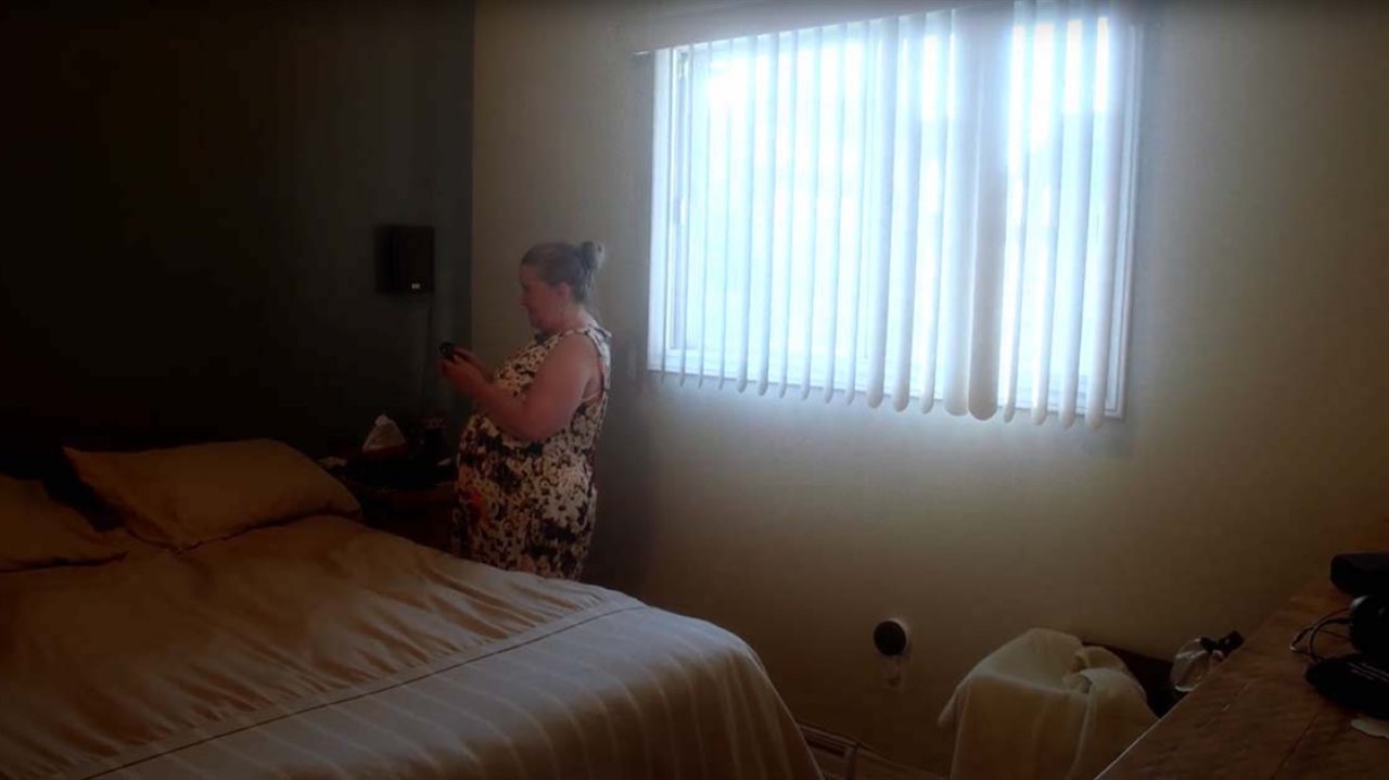 a woman standing in a bedroom