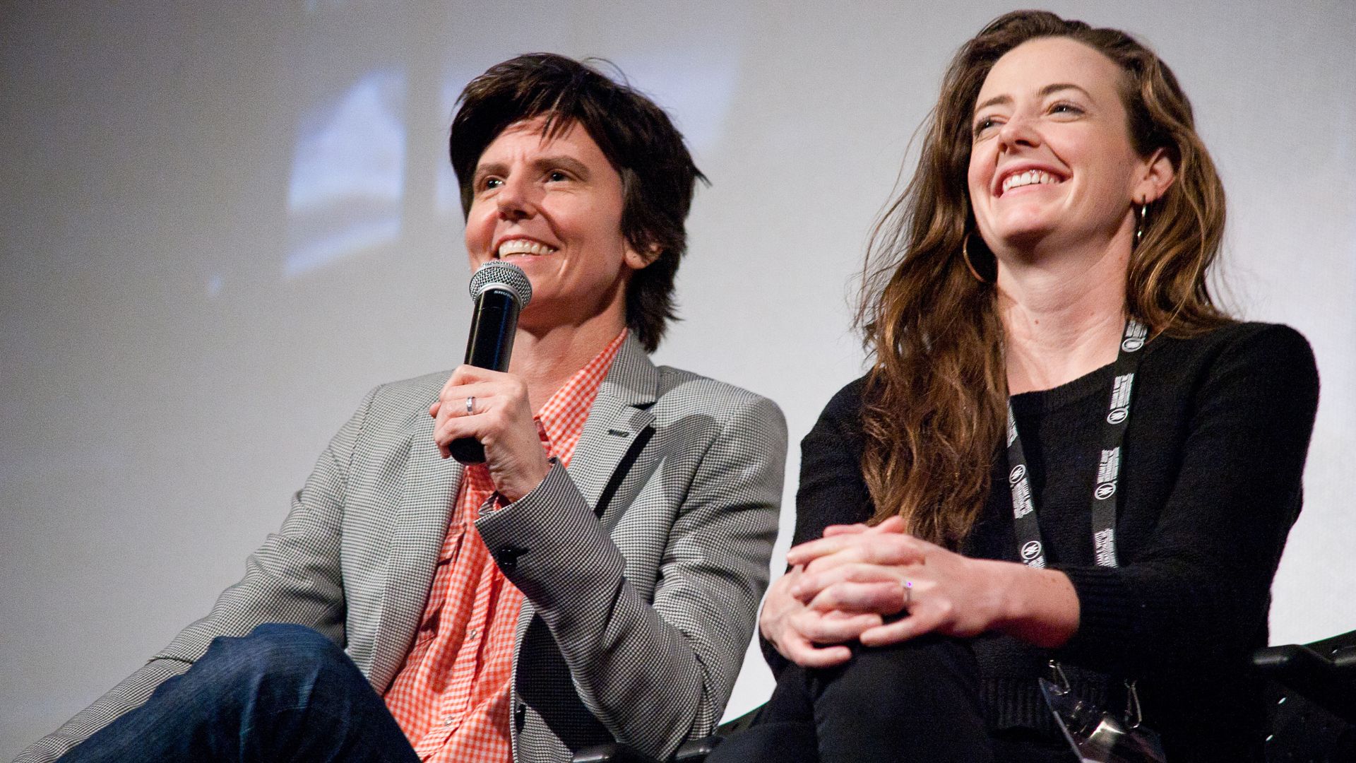 Tig Notaro holding a microphone during a Q and A session.